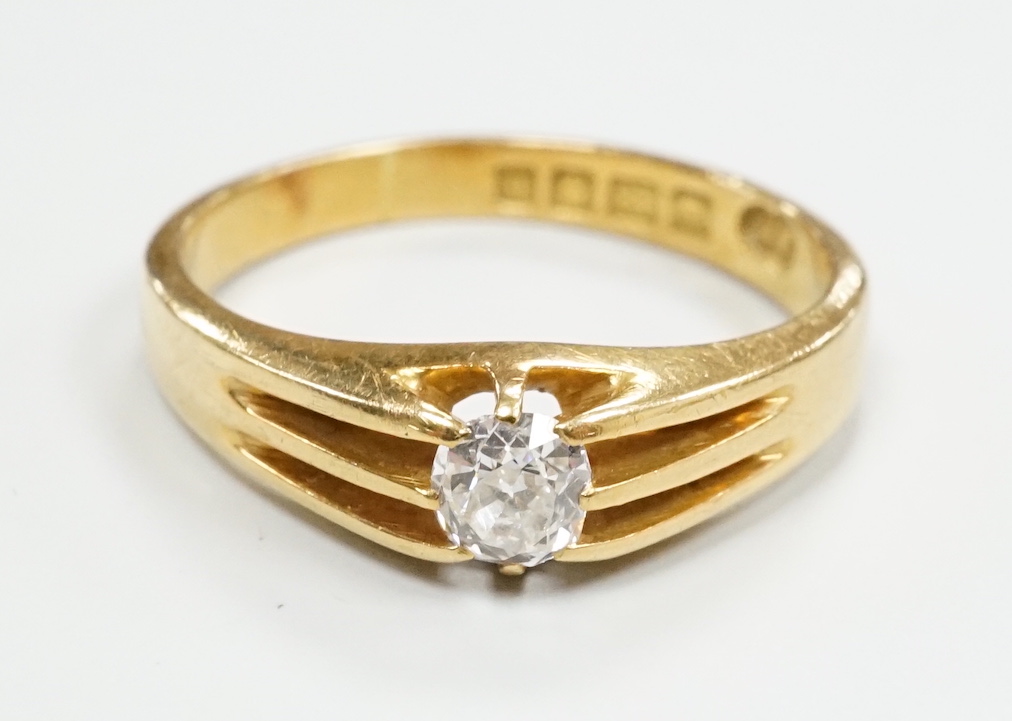A George V 18ct gold and claw set solitaire diamond ring, size R, gross weight 5.1 grams.